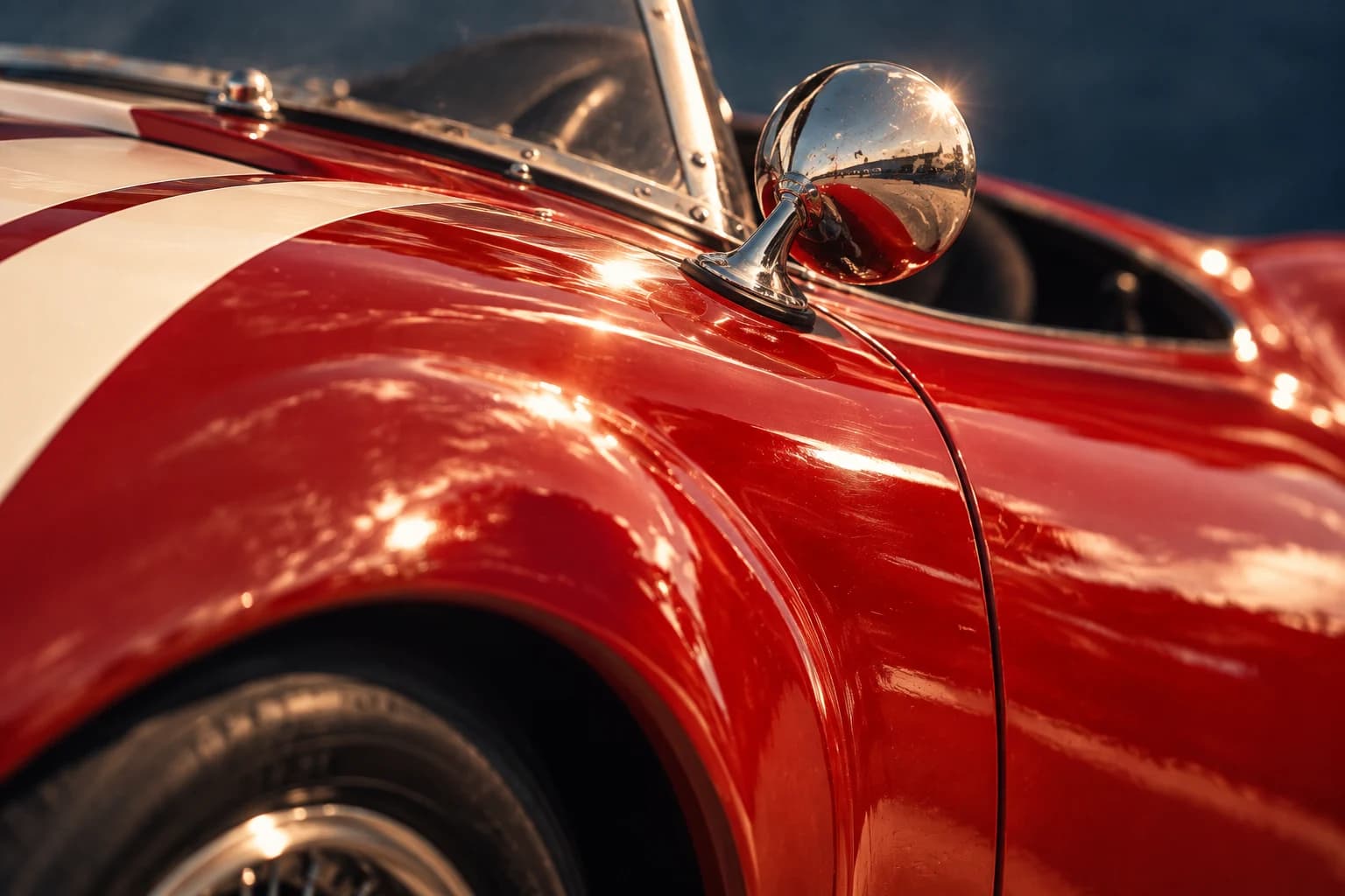 Glossy red vintage race car body and chrome side mirror